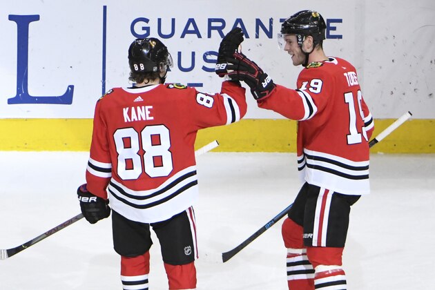 Chicago Blackhawks right wing Patrick Kane (88) celebrates his 1,000th point on an assist against the Winnipeg Jets with center Jonathan Toews (19) during the third period of an NHL hockey game Sunday, Jan. 19, 2020, in Chicago. (AP Photo/David Banks)
