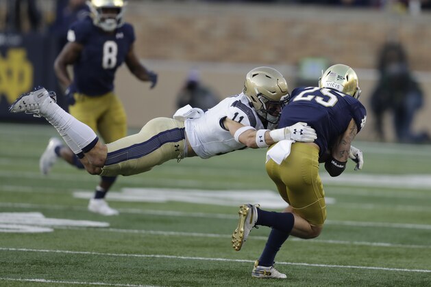 Notre Dame wide receiver Braden Lenzy (25) is tackled by Navy safety Evan Fochtman (11) during the second half of an NCAA college football game, Saturday, Nov. 16, 2019, in South Bend, Ind. Notre Dame won 52-20. (AP Photo/Darron Cummings)