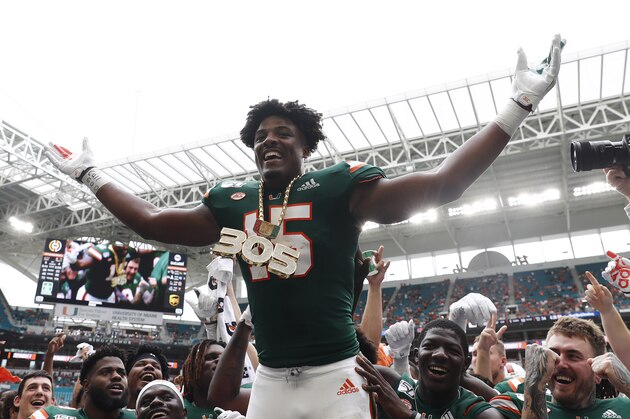 Miami defensive lineman Gregory Rousseau (15) celebrates a turnover and wears the turnover chain during the first half of an NCAA college football game against Central Michigan, Saturday, Sept. 21, 2019, in Miami Gardens, Fla. (AP Photo/Brynn Anderson)