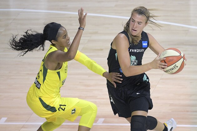 New York Liberty guard Sabrina Ionescu (20) drives to the basket in front of Seattle Storm guard Jordin Canada (21) during the second half of a WNBA basketball game, Saturday, July 25, 2020, in Bradenton, Fla. (AP Photo/Phelan M. Ebenhack)