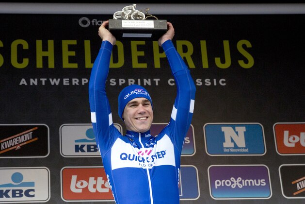 First place Netherland's Fabio Jakobsen from the Quick-Step team poses with his trophy on the podium after winning the Scheldeprijs cycling race in Schoten, Belgium on Wednesday, April 4, 2018. (AP Photo/Virginia Mayo)