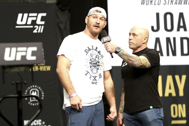 Stipe Miocic is interviewed by Joe Rogan during a weigh-in before UFC 211 on Friday, May 12, 2017, in Dallas before UFC 211. ( AP Photo/Gregory Payan)