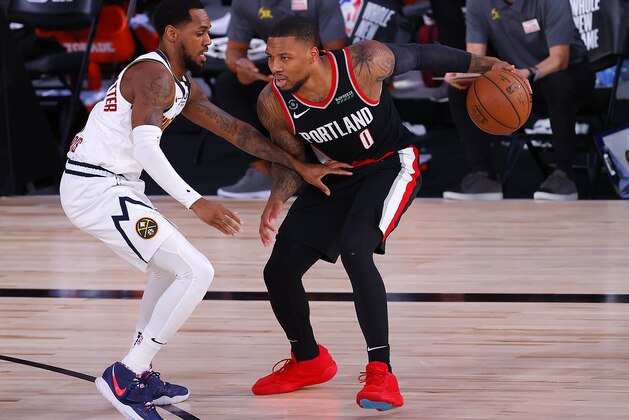 Denver Nuggets' Monte Morris (11) defends Portland Trail Blazers' Damian Lillard (0) during the first half of an NBA basketball game Thursday, Aug. 6, 2020, in Lake Buena Vista, Fla. (Kevin C. Cox/Pool Photo via AP)