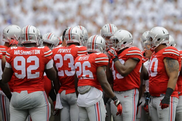 Ohio State players huddle in the first half of an NCAA college football game against Navy in Baltimore, Saturday, Aug. 30, 2014. (AP Photo/Patrick Semansky)