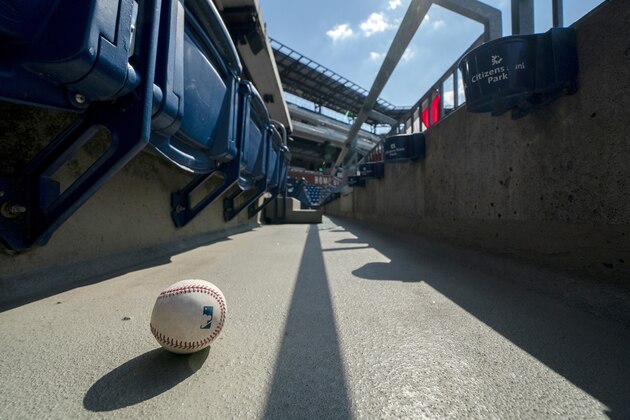 FILE - In this Sunday, July 26, 2020, file photo, a foul ball that was hit into the stands sits on the ground of an empty stadium during the eighth inning of a baseball game between the Miami Marlins and the Philadelphia Phillies in Philadelphia. The Marlinsâ€™ coronavirus outbreak could endanger the Major League Baseball season, Dr. Anthony Fauci said, as the number of their players testing positive rose to 15. The Marlins received positive test results for four additional players Tuesday, July 23, 2020, a person familiar with the situation told The Associated Press. The person declined to be identified because the results had not been publicly released. (AP Photo/Chris Szagola, File)
