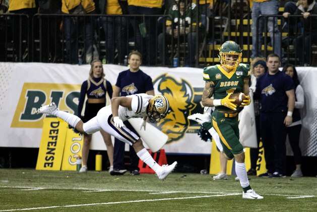 North Dakota State wide receiver Christian Watson (1) scores in the first half of an FCS playoff NCAA college football game against Montana State, Saturday, Dec. 21, 2019, in Fargo, N.D. (AP Photo/Bruce Crummy)