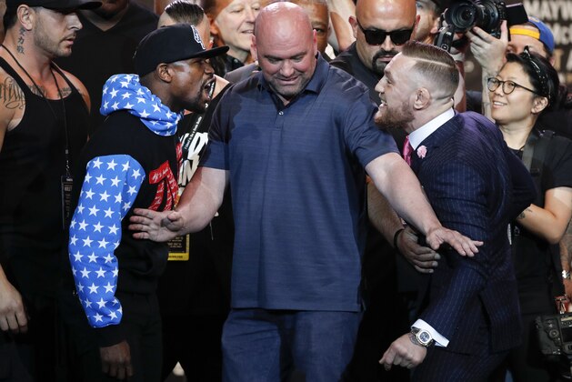UFC president Dana White, center, intervenes as boxer Floyd Mayweather Jr., left, and mixed martial arts fighter Conor McGregor exchange words during a news conference at Staples Center Tuesday, July 11, 2017, in Los Angeles. The two are scheduled to fight in a boxing match in Las Vegas on Aug. 26. (AP Photo/Jae C. Hong)