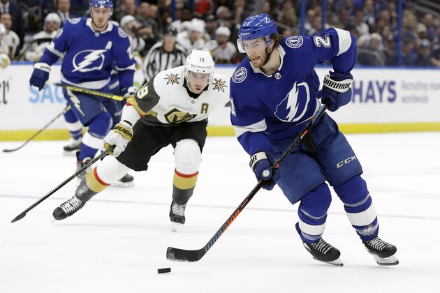 Tampa Bay Lightning center Brayden Point (21) carries the puck around Vegas Golden Knights right wing Reilly Smith (19) during the second period of an NHL hockey game Tuesday, Feb. 4, 2020, in Tampa, Fla. (AP Photo/Chris O'Meara) Tampa Bay Lightning center Brayden Point (21) carries the puck around Vegas Golden Knights right wing Reilly Smith (19) during the second period of an NHL hockey game Tuesday, Feb. 4, 2020, in Tampa, Fla. (AP Photo/Chris O'Meara)