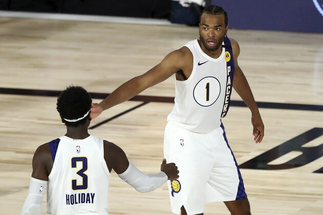 Indiana Pacers forward T.J. Warren (1) celebrates with guard Aaron Holiday (3) during the fourth quarter of an NBA basketball game against the Los Angeles Lakers, Saturday, Aug. 8, 2020, in Lake Buena Vista, Fla. (Kim Klement/Pool Photo via AP) Indiana Pacers forward T.J. Warren (1) celebrates with guard Aaron Holiday (3) during the fourth quarter of an NBA basketball game against the Los Angeles Lakers, Saturday, Aug. 8, 2020, in Lake Buena Vista, Fla. (Kim Klement/Pool Photo via AP)