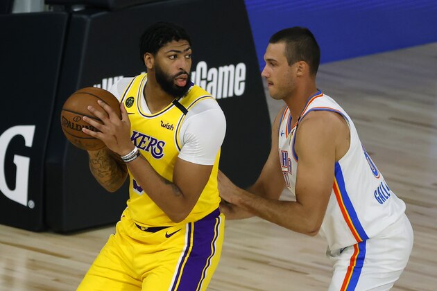 Los Angeles Lakers' Anthony Davis, left, is defended by Oklahoma City Thunder's Danilo Gallinari during the first half of an NBA basketball game Wednesday, Aug. 5, 2020, in Lake Buena Vista, Fla. (Kevin C. Cox/Pool Photo via AP)