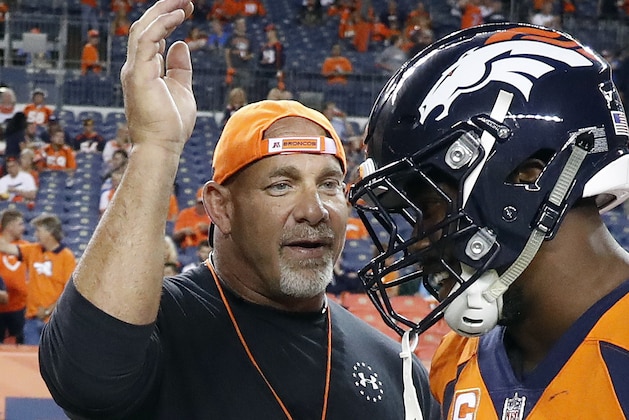 FILE - In this Sept. 11, 2017, file photo, professional wrestler Bill Goldberg, left,  greets Denver Broncos outside linebacker Von Miller prior to an NFL football game against the Los Angeles Chargers, Monday, Sept. 11, 2017, in Denver. Bill Goldberg found his toughest tag-team partner yet.