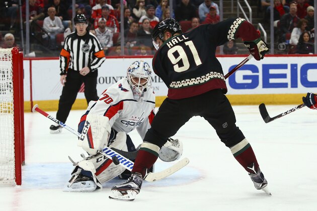 Washington Capitals goaltender Braden Holtby (70) makes a save on a shot by Arizona Coyotes left wing Taylor Hall (91) during the second period of an NHL hockey game Saturday, Feb. 15, 2020, in Glendale, Ariz. (AP Photo/Ross D. Franklin)