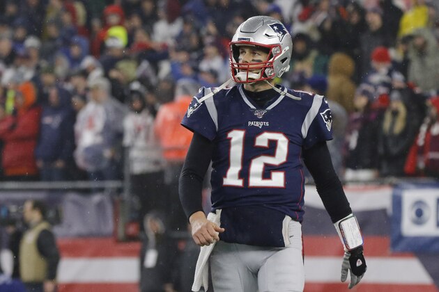 FILE - In this Jan. 4, 2020, file photo, New England Patriots quarterback Tom Brady walks to the sideline after throwing an interception late in the second half of an NFL wild-card playoff football game against the Tennessee Titans in Foxborough, Mass. Atlanta Falcons coach Dan Quinn says the NFC South “is turning into Quarterback South.” Tom Brady's arrival has raised the stakes. (AP Photo/Bill Sikes, File)