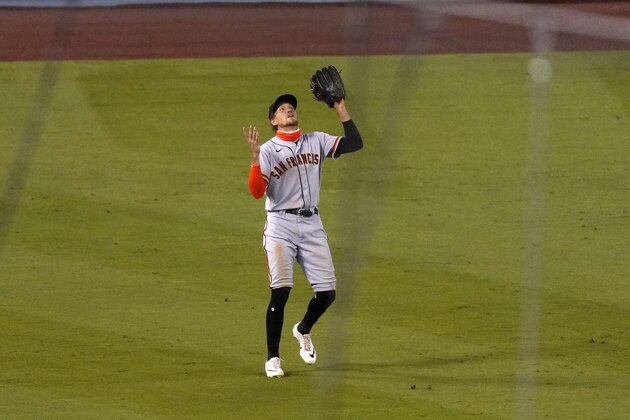 San Francisco Giants left fielder Hunter Pence can't find a fly ball hit by Los Angeles Dodgers' Enrique HernÃ¡ndez for a triple during the sixth inning of a baseball game Saturday, Aug. 8, 2020, in Los Angeles. (AP Photo/Mark J. Terrill)