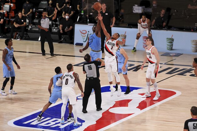 Memphis Grizzlies Jaren Jackson Jr. (13) and Portland Trail Blazers CJ McCollum (3) compete for a jump ball during the second half of an NBA basketball game Friday, July 31, 2020, in Lake Buena Vista, Fla. (Mike Ehrmann/Pool Photo via AP)