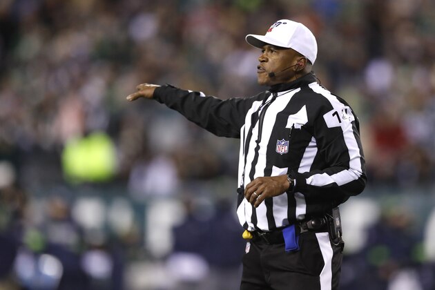 NFL referee Shawn Smith (14) gestures after a penalty against the Seattle Seahawks during the first half of an NFL wild-card playoff football game against the Philadelphia Eagles, Sunday, Jan. 5, 2020, in Philadelphia. The Seahawks won 17-9. (AP Photo/Julio Cortez)