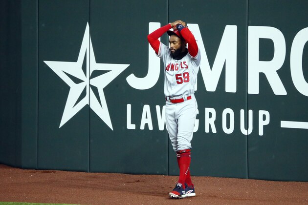 Los Angeles Angels right fielder Jo Adell puts his hands on his head after a fly ball by Texas Rangers' Nick Solak popped out of his glove and over the right field wall for a solo home run during the fifth inning of a baseball game in Arlington, Texas, Sunday, Aug. 9, 2020. (AP Photo/Ray Carlin)