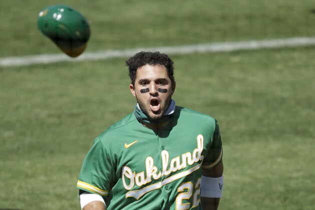 Oakland Athletics' Ramon Laureano (22) charges the Houston Astros dugout after being hit by a pitch thrown by Andre Scrubb in the seventh inning of a baseball game Sunday, Aug. 9, 2020, in Oakland, Calif. (AP Photo/Ben Margot)