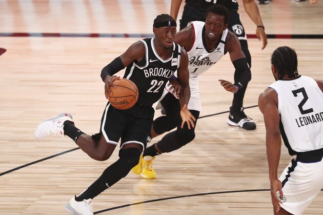 Brooklyn Nets guard Caris LeVert (22) dribbles the ball against Los Angeles Clippers guard Reggie Jackson (1) in the first half of an NBA basketball game Sunday, Aug. 9, 2020, in Lake Buena Vista, Fla. (Kim Klement/Pool Photo via AP)