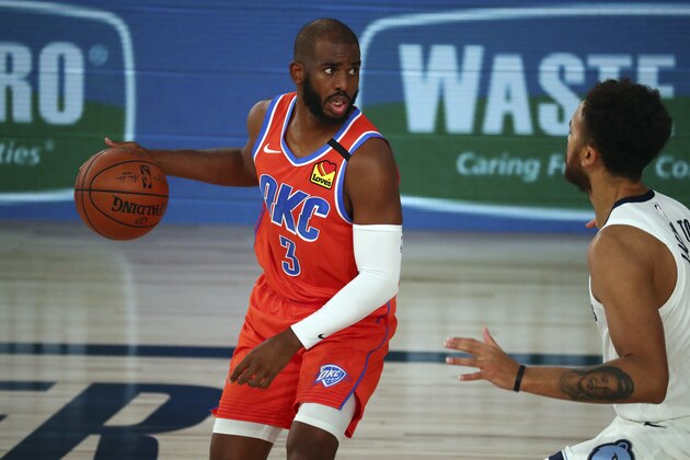 Oklahoma City Thunder guard Chris Paul (3) controls the ball against Memphis Grizzlies forward Kyle Anderson (1) during the first half of an NBA basketball game Friday, Aug. 7, 2020, in Lake Buena Vista, Fla. (Kim Klement/Pool Photo via AP)