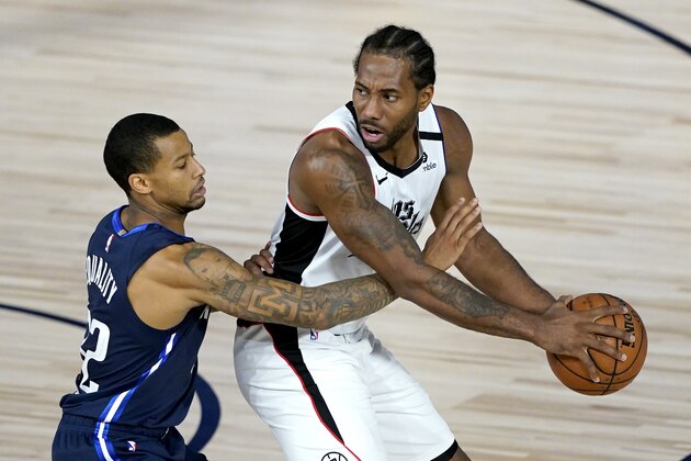 Los Angeles Clippers' Kawhi Leonard, right, is guarded by Dallas Mavericks' Trey Burke (32) during the second half of an NBA basketball game Thursday, Aug. 6, 2020 in Lake Buena Vista, Fla. (AP Photo/Ashley Landis, Pool)