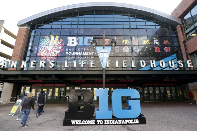 Fans enter The Bankers Life Fieldhouse for an NCAA college basketball game at the Big Ten Conference tournament in Indianapolis, Thursday, March 12, 2020. The Big Ten Conference announced Thursday, that remainder of the games in the men's NCAA college basketball tournament were cancelled. (AP Photo/Michael Conroy)