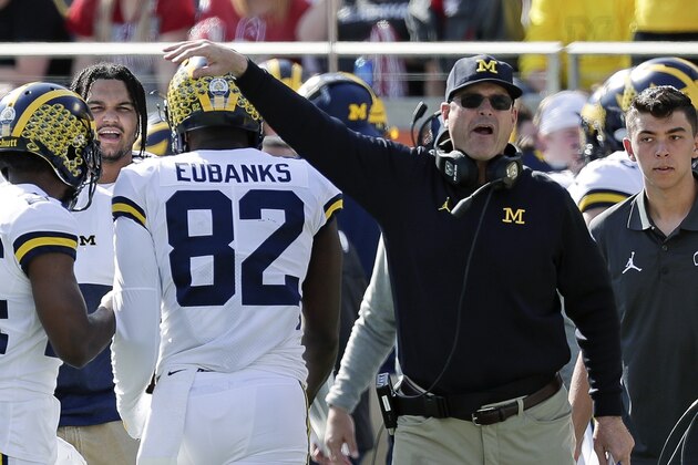 Michigan head coach Jim Harbaugh, right, congratulates tight end Nick Eubanks (82) after he caught a 7-yard touchdown pass against Alabama during the first half of the Citrus Bowl NCAA college football game, Wednesday, Jan. 1, 2020, in Orlando, Fla. (AP Photo/John Raoux) Michigan head coach Jim Harbaugh, right, congratulates tight end Nick Eubanks (82) after he caught a 7-yard touchdown pass against Alabama during the first half of the Citrus Bowl NCAA college football game, Wednesday, Jan. 1, 2020, in Orlando, Fla. (AP Photo/John Raoux)
