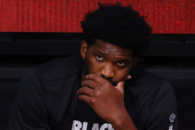 Philadelphia 76ers' Joel Embiid looks on from the bench after being injured earlier in an NBA basketball game against the Portland Trail Blazers during the third quarter of an NBA basketball game Sunday, Aug. 9, 2020, in Lake Buena Vista, Fla. (Kevin C. Cox/Pool Photo via AP)