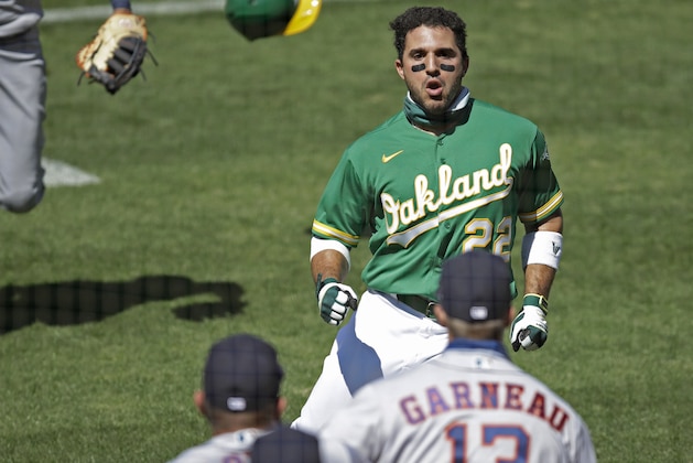 Oakland Athletics' Ramon Laureano (22) charges the Houston Astros' dugout after being hit by a pitch thrown by Humberto Castellanos during the seventh inning of a baseball game Sunday, Aug. 9, 2020, in Oakland, Calif. (AP Photo/Ben Margot)