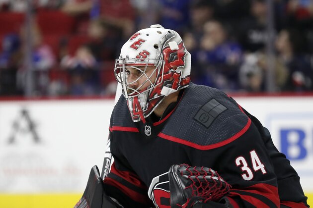 Carolina Hurricanes goaltender Petr Mrazek (34) keeps an eye on the puck during the first period of an NHL hockey game against the New York Rangers in Raleigh, N.C., Friday, Feb. 21, 2020. (AP Photo/Gerry Broome)
