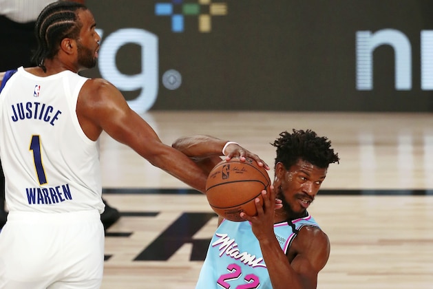 Indiana Pacers forward T.J. Warren (1) fouls Miami Heat forward Jimmy Butler (22) during the first half of an NBA basketball game Monday, Aug. 10, 2020, in Lake Buena Vista, Fla. (Kim Klement/Pool Photo via AP)