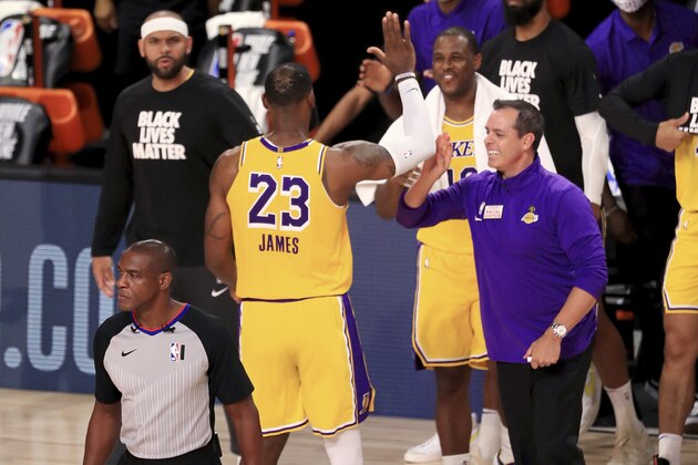 Los Angeles Lakers' LeBron James (23)celebrates with coach Frank Vogel after the Lakers defeated the Los Angeles Clippers in an NBA basketball game Thursday, July 30, 2020, in Lake Buena Vista, Fla. (Mike Ehrmann/Pool Photo via AP)