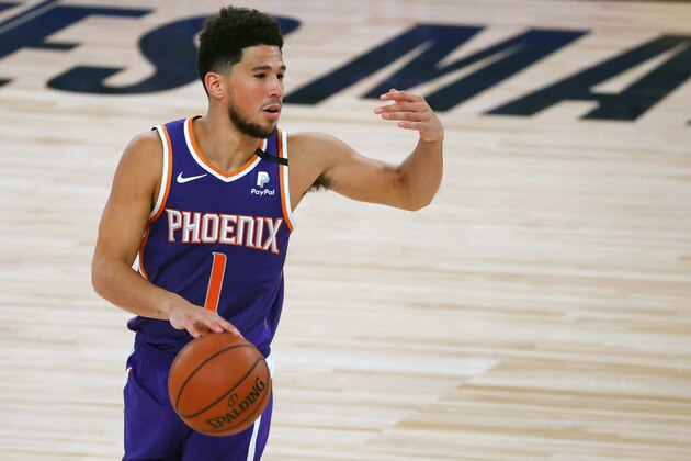 Phoenix Suns' Devin Booker directs his teammates during an NBA basketball game against the Los Angeles Clippers' Tuesday, Aug. 4, 2020, in Lake Buena Vista, Fla. (Kevin C. Cox/Pool Photo via AP)