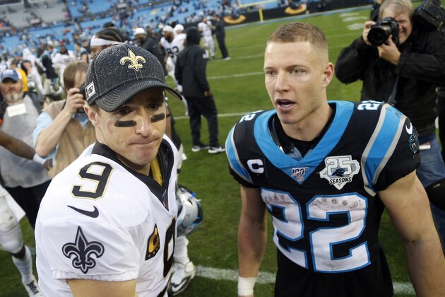 New Orleans Saints quarterback Drew Brees (9) and Carolina Panthers running back Christian McCaffrey (22) speak following an NFL football game in Charlotte, N.C., Sunday, Dec. 29, 2019. (AP Photo/Brian Blanco)