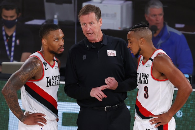 Portland Trail Blazers coach Terry Stotts talks with Damian Lillard, left, and CJ McCollum during the fourth quarter of the team's NBA basketball game against the Philadelphia 76ers on Sunday, Aug. 9, 2020, in Lake Buena Vista, Fla. (Kevin C. Cox/Pool Photo via AP) Portland Trail Blazers coach Terry Stotts talks with Damian Lillard, left, and CJ McCollum during the fourth quarter of the team's NBA basketball game against the Philadelphia 76ers on Sunday, Aug. 9, 2020, in Lake Buena Vista, Fla. (Kevin C. Cox/Pool Photo via AP)