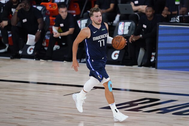 Dallas Mavericks guard Luka Doncic (77) brings the ball up court against the Phoenix Suns during the first half of an NBA basketball game Sunday, Aug. 2, 2020, in Lake Buena Vista, Fla. (AP Photo/Ashley Landis, Pool)
