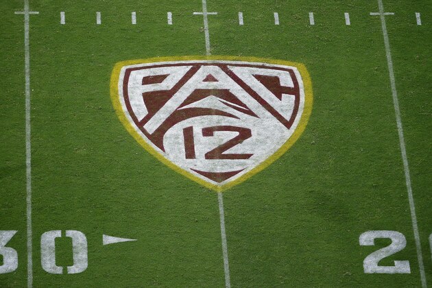 FILE - In this Aug. 29, 2019, file photo, the Pac-12 logo is displayed on the field at Sun Devil Stadium during an NCAA college football game between Arizona State and Kent State in Tempe, Ariz. As the wealthiest conferences  like the Pac-12 lay out plans they hope will protect athletes from contracting and spreading COVID-19, most of the schools in the second-tier of Division I football have given up on trying to play in the fall. (AP Photo/Ralph Freso, File)