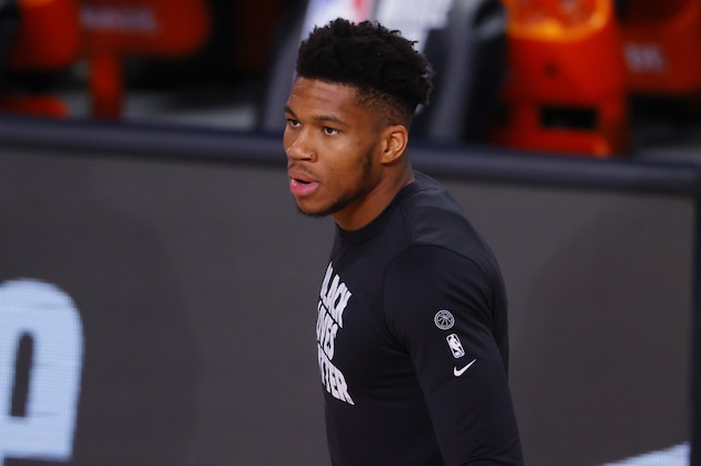 Milwaukee Bucks' Giannis Antetokounmpo looks on during warmups before an NBA basketball game against the Dallas Mavericks, Saturday, Aug. 8, 2020, in Lake Buena Vista, Fla. (Kevin C. Cox/Pool Photo via AP)