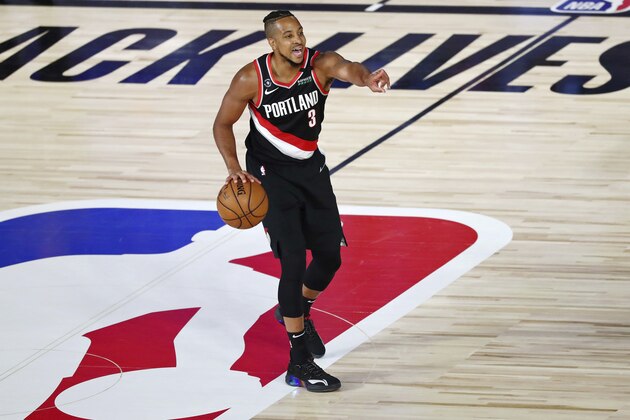 Portland Trail Blazers guard CJ McCollum (3) gestures while dribbling at mid court against the Dallas Mavericks during the second half of an NBA basketball game Tuesday, Aug. 11, 2020, in Lake Buena Vista, Fla. (Kim Klement/Pool Photo via AP)