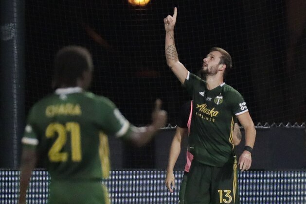 Portland Timbers defender Dario Zuparic (13) gestures, after scoring a goal during the second half of an MLS soccer match, Tuesday, Aug. 11, 2020, in Kissimmee, Fla. (AP Photo/John Raoux)