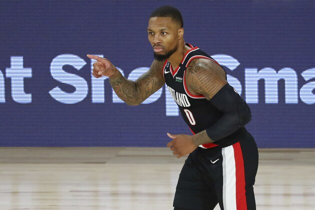 Portland Trail Blazers guard Damian Lillard reacts after making a 3-point basket against the Dallas Mavericks during the second half of an NBA basketball game Tuesday, Aug. 11, 2020, in Lake Buena Vista, Fla. (Kim Klement/Pool Photo via AP)