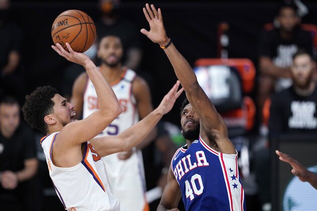 Phoenix Suns guard Devin Booker (1)takes a shot over Philadelphia 76ers forward Glenn Robinson III (40) during the second half of an NBA basketball game Tuesday, Aug. 11, 2020, in Lake Buena Vista, Fla. (AP Photo/Ashley Landis, Pool)