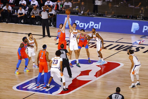 Oklahoma City Thunder's Mike Muscala (33) and Phoenix Suns' Dario Saric (20) go up for the tip off at the start of an NBA basketball game Monday, Aug. 10, 2020, in Lake Buena Vista, Fla. (Mike Ehrmann/Pool Photo via AP)