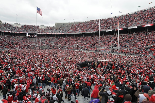In this Nov. 24, 2012 photo, Ohio State fans celebrate on the field after a win over Michigan in an NCAA college football game in Columbus, Ohio. Ahead of the 2014 college football season, the AP asked its panel of Top 25 voters, who are known for ranking the nation's top teams each week, to weigh in on which stadium had the best game day atmosphere. Ohio State’s Horseshoe received recognition from the panel. (AP Photo/Mark Duncan, File) In this Nov. 24, 2012 photo, Ohio State fans celebrate on the field after a win over Michigan in an NCAA college football game in Columbus, Ohio. Ahead of the 2014 college football season, the AP asked its panel of Top 25 voters, who are known for ranking the nation's top teams each week, to weigh in on which stadium had the best game day atmosphere. Ohio State’s Horseshoe received recognition from the panel. (AP Photo/Mark Duncan, File)