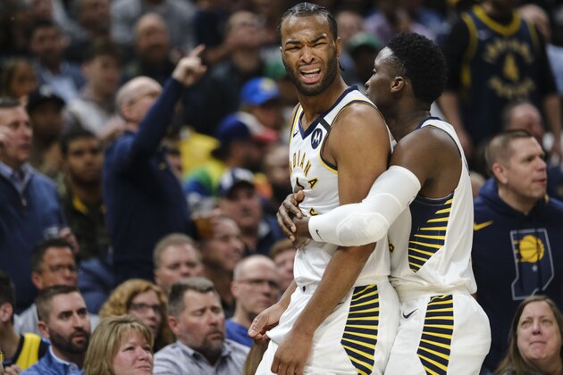 Indiana Pacers forward T.J. Warren, left, is restrained by teammate Victor Oladipo after Warren was called for a technical foul during the first half of the team's NBA basketball game against the Boston Celtics in Indianapolis, Tuesday, March 10, 2020. (AP Photo/AJ Mast)