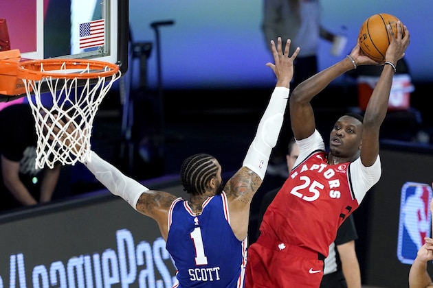 Toronto Raptors' Chris Boucher (25) goes up for a shot against Philadelphia 76ers' Mike Scott (1) during the second half of an NBA basketball game Wednesday, Aug. 12, 2020 in Lake Buena Vista, Fla. (AP Photo/Ashley Landis, Pool)
