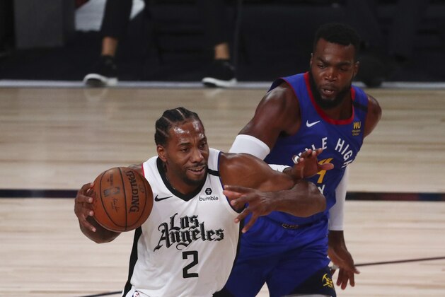 Los Angeles Clippers' forward Kawhi Leonard (2) drives to the basket past Denver Nuggets forward Paul Millsap (4) during the first half of an NBA basketball game Wednesday, Aug. 12, 2020, in Lake Buena Vista, Fla. (Kim Klement/Pool Photo via AP)