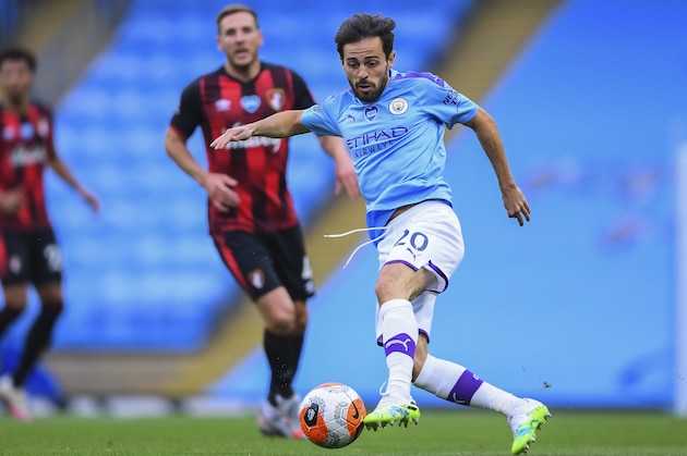 Manchester City's Bernardo Silva, right, runs with the ball during the English Premier League soccer match between Manchester City and Bournemouth at the Ethiad Stadium in Manchester, England, Wednesday, July 15, 2020. (Laurence Griffiths/Pool via AP)