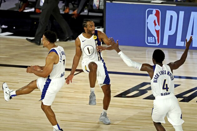Indiana Pacers forward T.J. Warren (1) celebrates with guards Malcolm Brogdon (7) and Victor Oladipo (4) after a play against the Los Angeles Lakers during an NBA basketball game Saturday, Aug. 8, 2020, in Lake Buena Vista, Fla. (Kim Klement/Pool Photo via AP) Indiana Pacers forward T.J. Warren (1) celebrates with guards Malcolm Brogdon (7) and Victor Oladipo (4) after a play against the Los Angeles Lakers during an NBA basketball game Saturday, Aug. 8, 2020, in Lake Buena Vista, Fla. (Kim Klement/Pool Photo via AP)