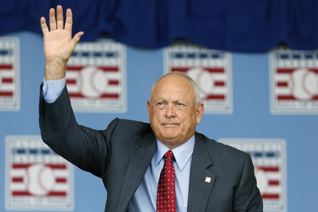 National Baseball Hall of Famer Nolan Ryan   waves to fans during an induction ceremony at the Clark Sports Center on Sunday, July 27, 2014, in Cooperstown, N.Y. (AP Photo/Mike Groll)